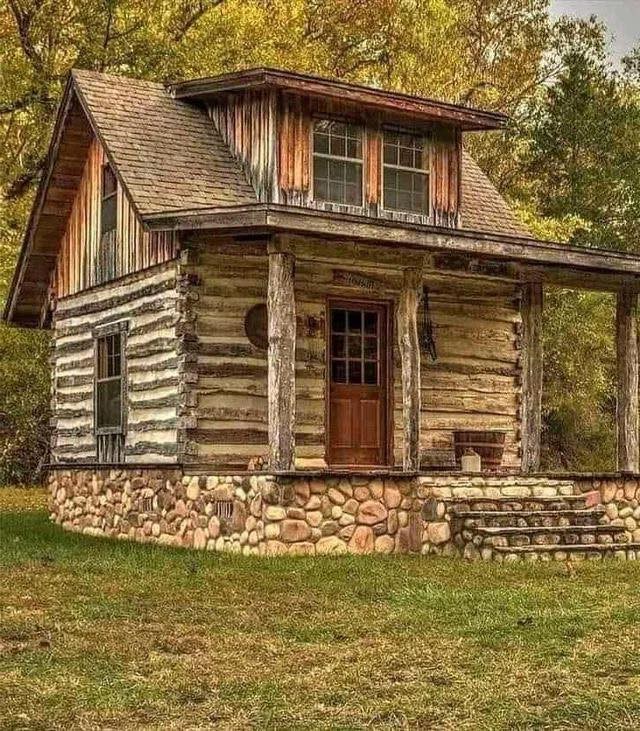 Okay, let's break down this image of a log cabin through several theoretical lenses. Note that some of these lenses will be a stronger fit than others. **1. Visual Description** The image depicts a small, rustic log c...
