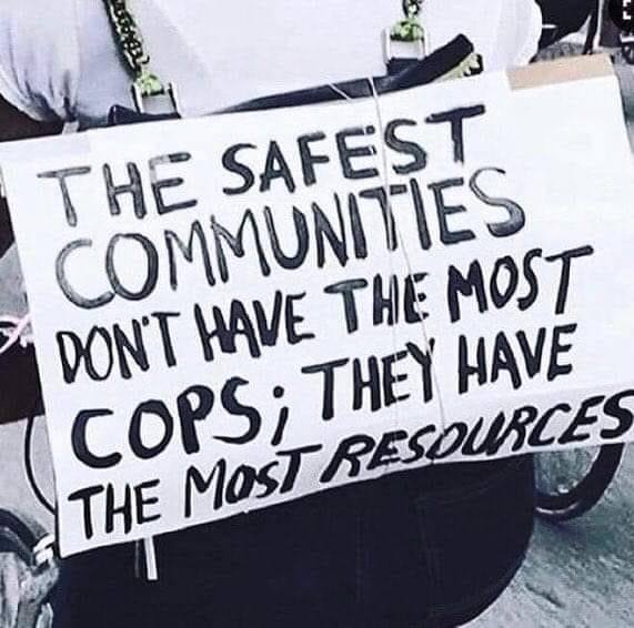 Okay, let's break down the image of the protest sign with the provided theoretical frameworks. **Visual Description** The image shows a close-up of a hand-written protest sign held by an individual. The sign is made o...