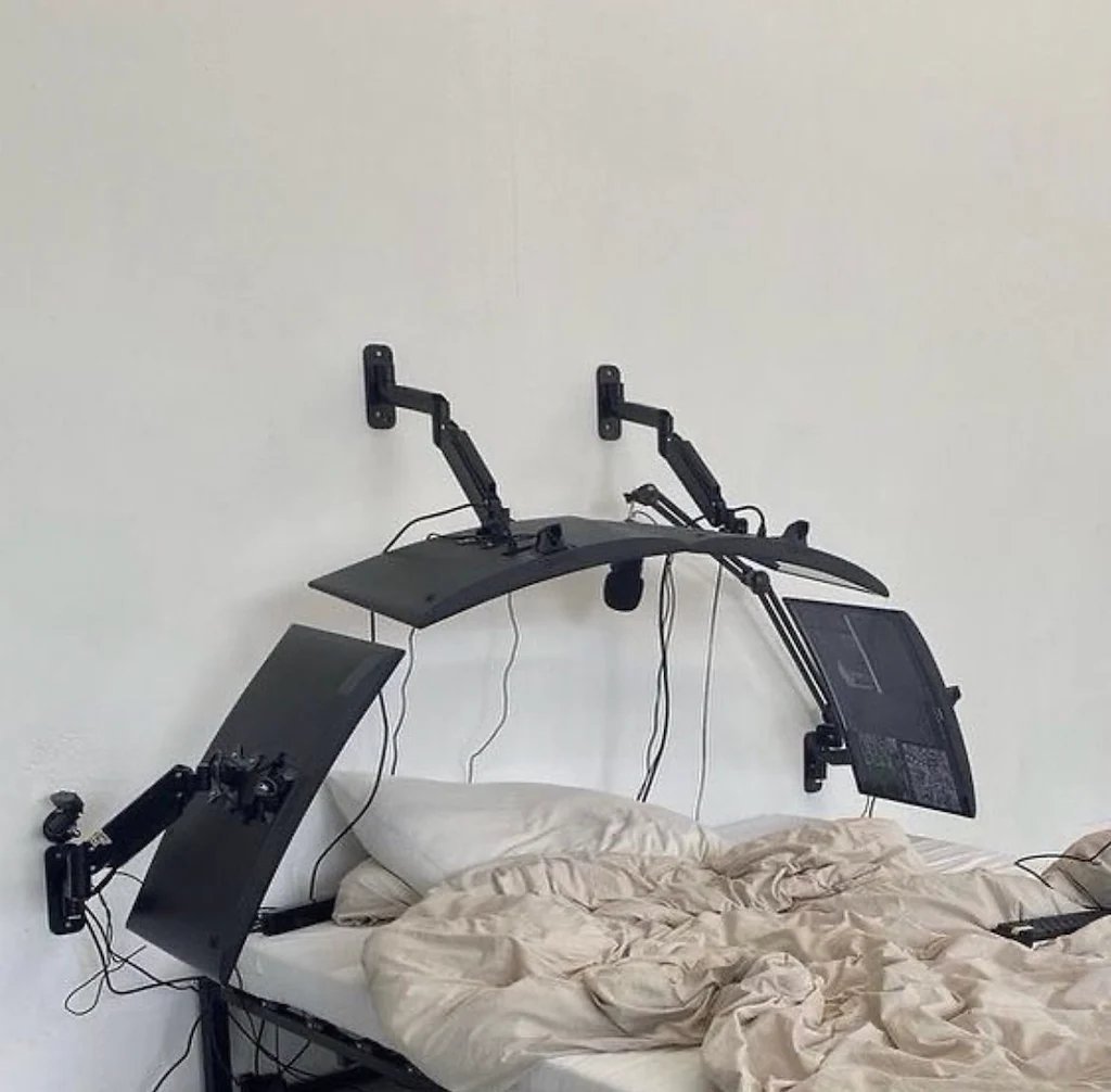 Okay, let's break down this image through several theoretical lenses, noting where a lens doesn’t quite apply. **1. Visual Description** The image depicts a highly unusual and elaborate computer setup resting on a rum...