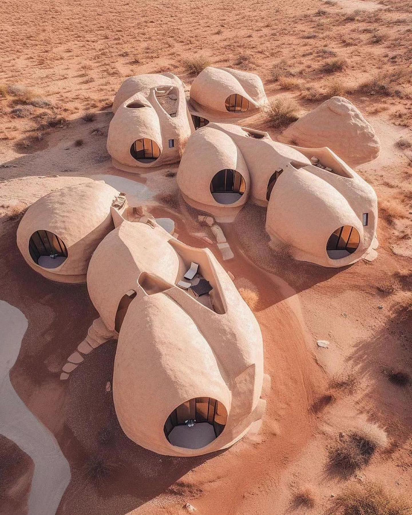 Okay, let's break down an analysis of the image, addressing each of the requested theoretical lenses where appropriate. **Visual Description** The image depicts a cluster of unusual, organic-looking structures built i...