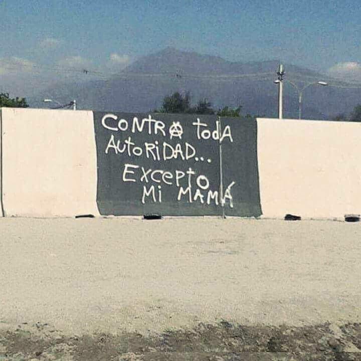 Okay, let's break down this image through the requested theoretical lenses. ## Visual Description The image depicts a handwritten message on a dark, rectangular board or wall in an outdoor setting. The message, writte...