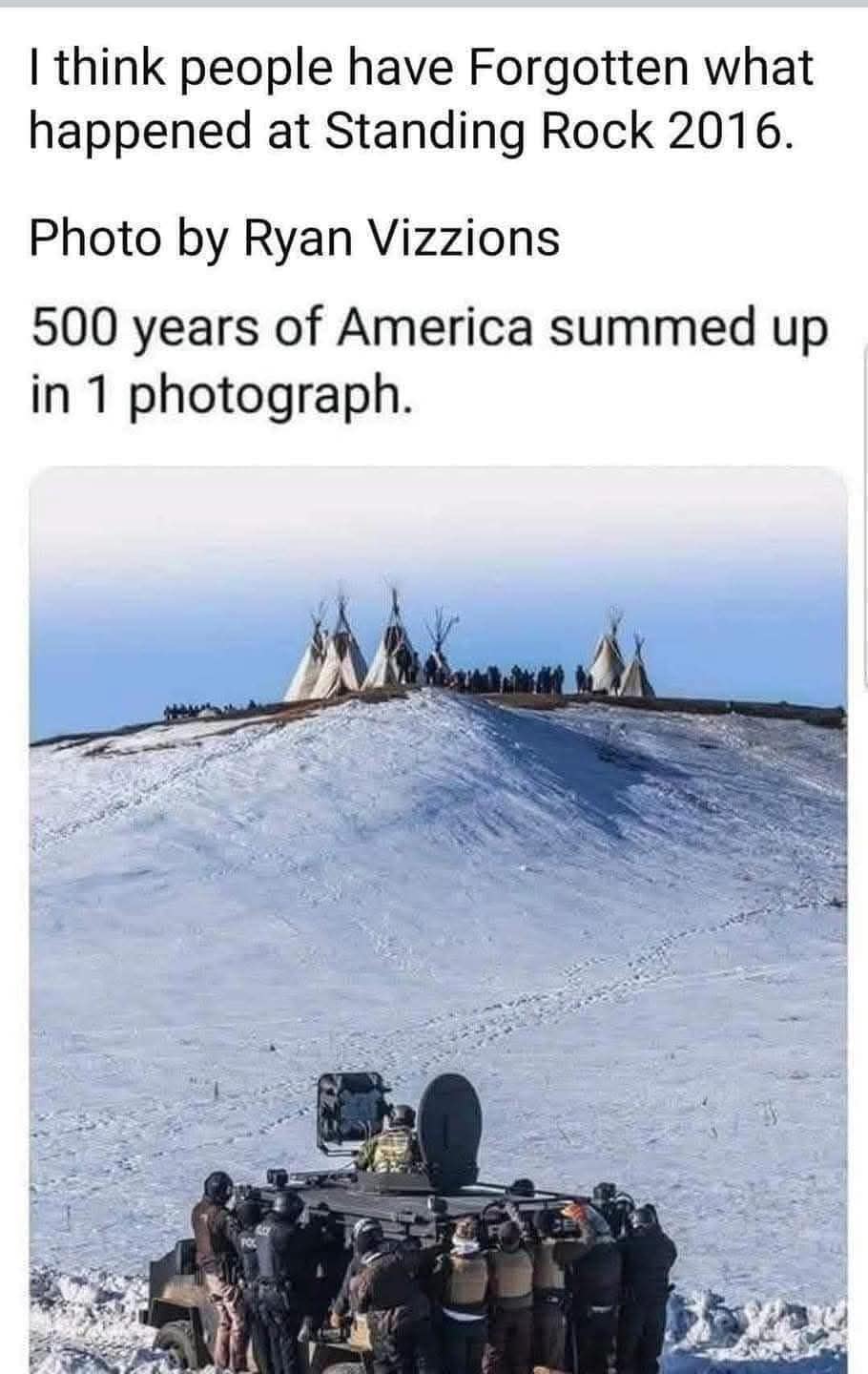 Okay, let's break down this powerful image, titled with a strong statement about collective memory and the events at Standing Rock in 2016, through a series of theoretical lenses. **Visual Description** The photograph...
