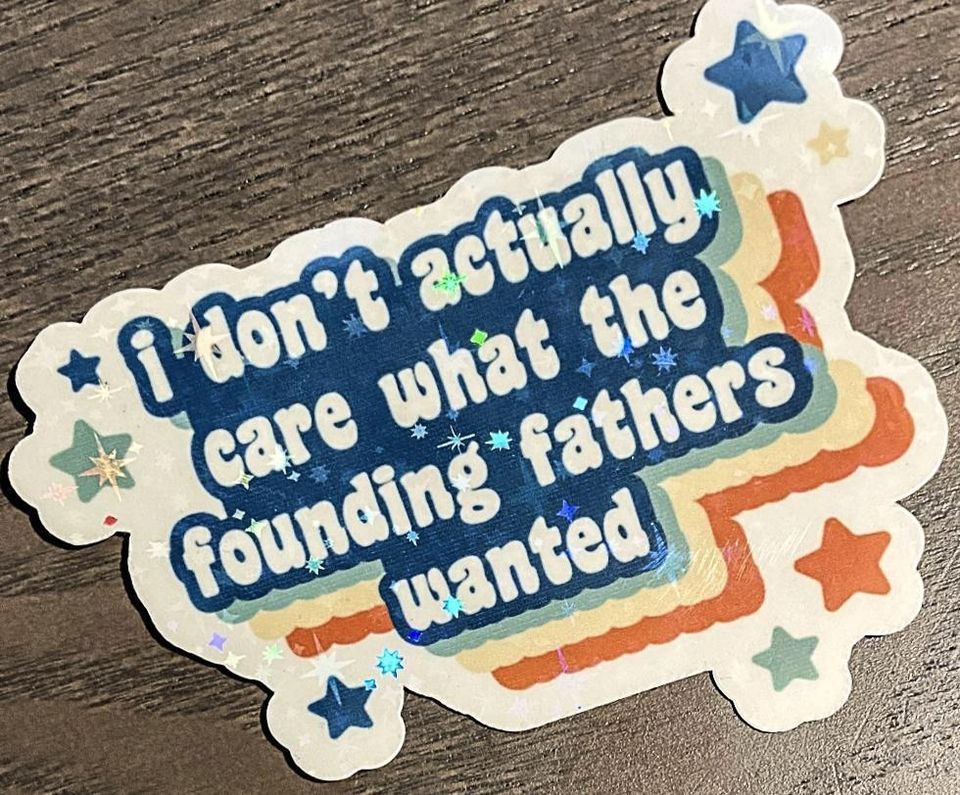 Okay, here's an analysis of the sticker, broken down into the requested sections. Keep in mind, these are interpretations, and a single image can support multiple readings. **Visual Description** The image is of a sti...