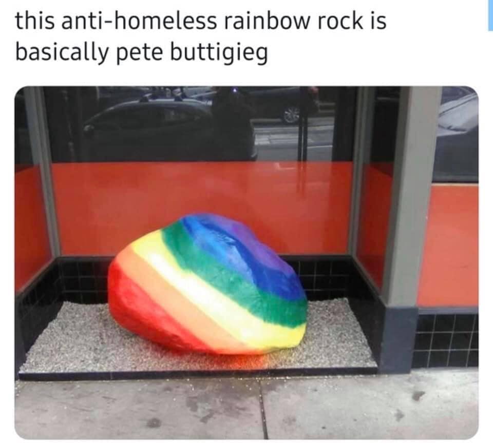 Okay, let's break down the image and its framing caption ("this anti-homeless rainbow rock is basically Pete Buttigieg") through the lenses you requested. It's a meme, so we have to consider the inherent satirical con...