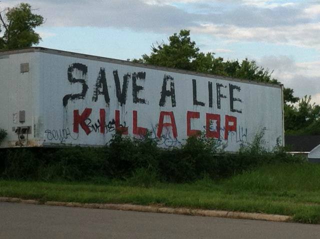 Here's an analysis of the image, broken down by the requested theoretical frameworks, noting where certain frameworks *don't* apply strongly. **Visual Description** The image depicts graffiti on the side of a large, l...