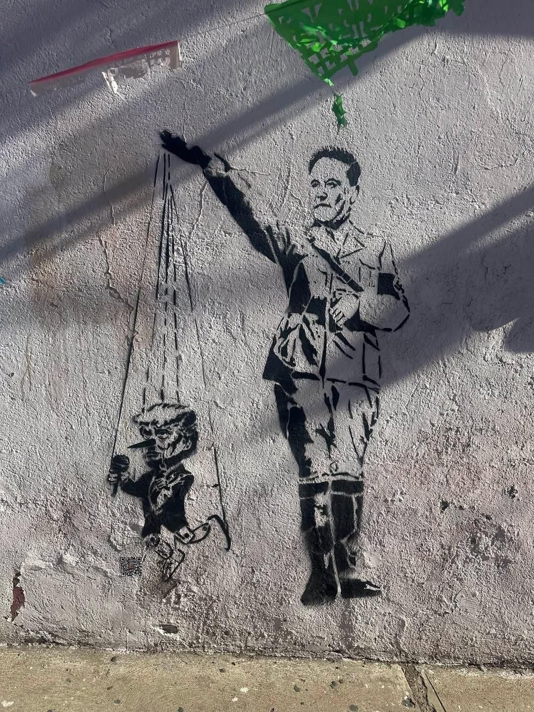 Okay, let's break down this striking image through the requested theoretical lenses. ## Visual Description The image is a monochromatic stencil-style street art piece painted on a heavily textured concrete wall. A fig...