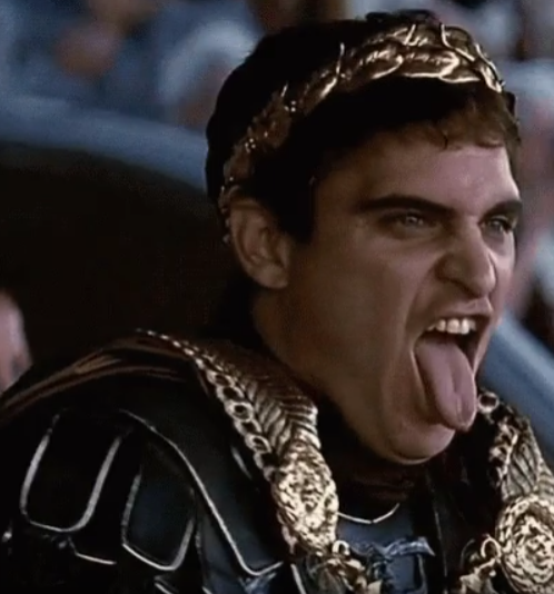 Okay, let's analyze the image of Joaquin Phoenix as Commodus in "Gladiator" using the requested theoretical frameworks. **Visual Description** The image captures Joaquin Phoenix in character as the Roman Emperor Commo...