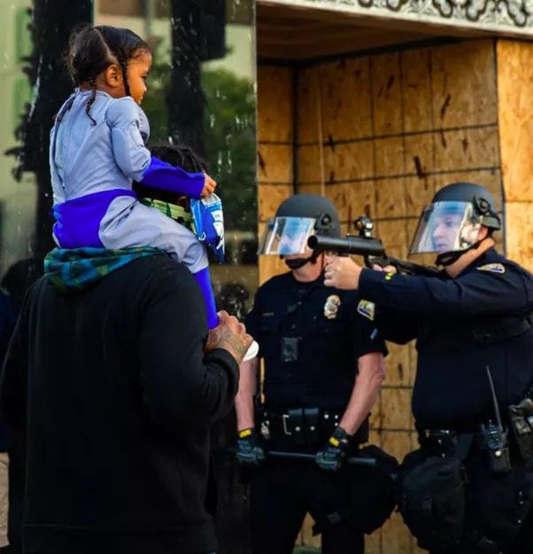 Okay, let's break down this powerful and disturbing image through the lens of several theoretical frameworks. **Please be aware:** This image is emotionally charged, and the analyses will inevitably touch on sensitive...