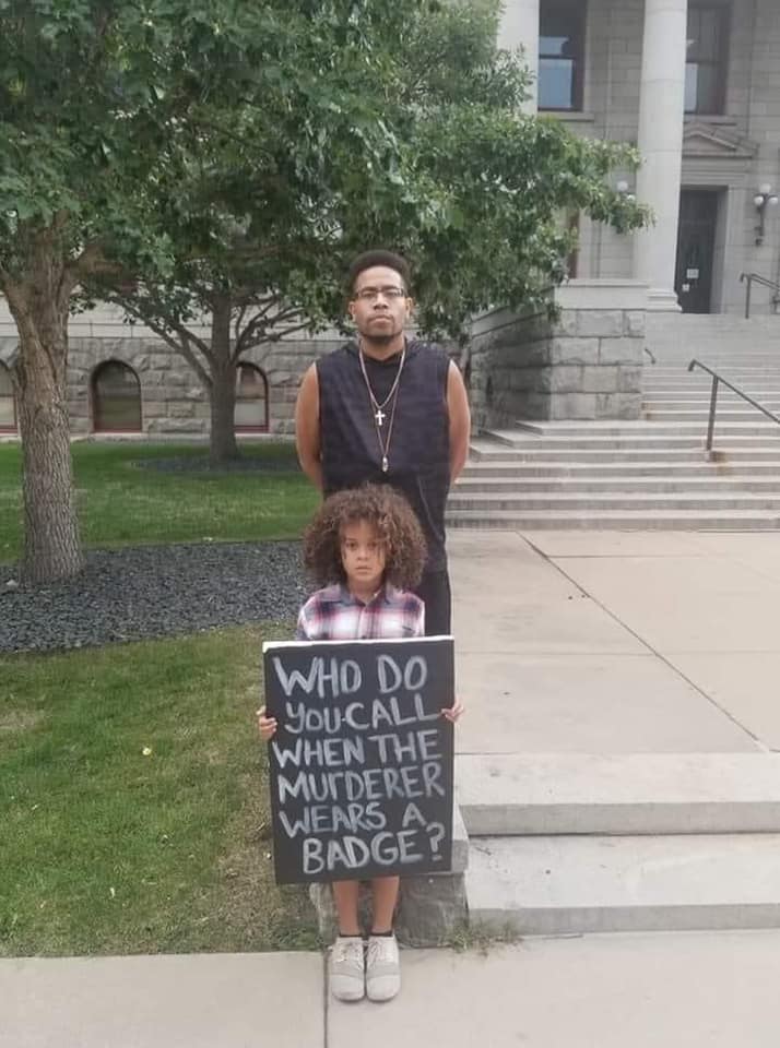 Okay, here's an analysis of the image, broken down into the requested sections, only addressing those sections where relevant to the content of the image. **Visual Description** The photograph depicts a young Black ch...