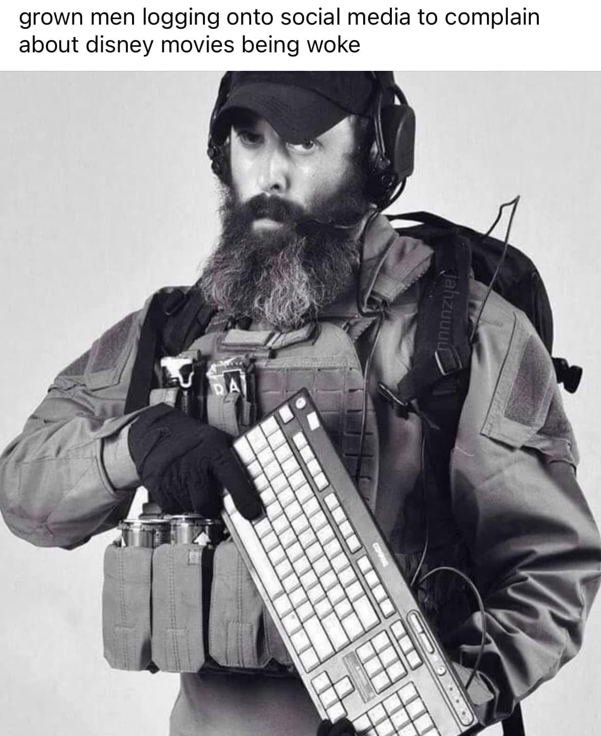 Okay, let's break down this image through the lenses of several theoretical frameworks. It's a layered image ripe for analysis! **Visual Description** The image depicts a man in tactical gear – a vest with pouches, a...