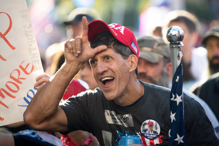 Okay, let's break down this image using the frameworks requested. Keep in mind these are interpretive exercises and other readings are possible. **Visual Description** The image depicts a man seemingly in the midst of...