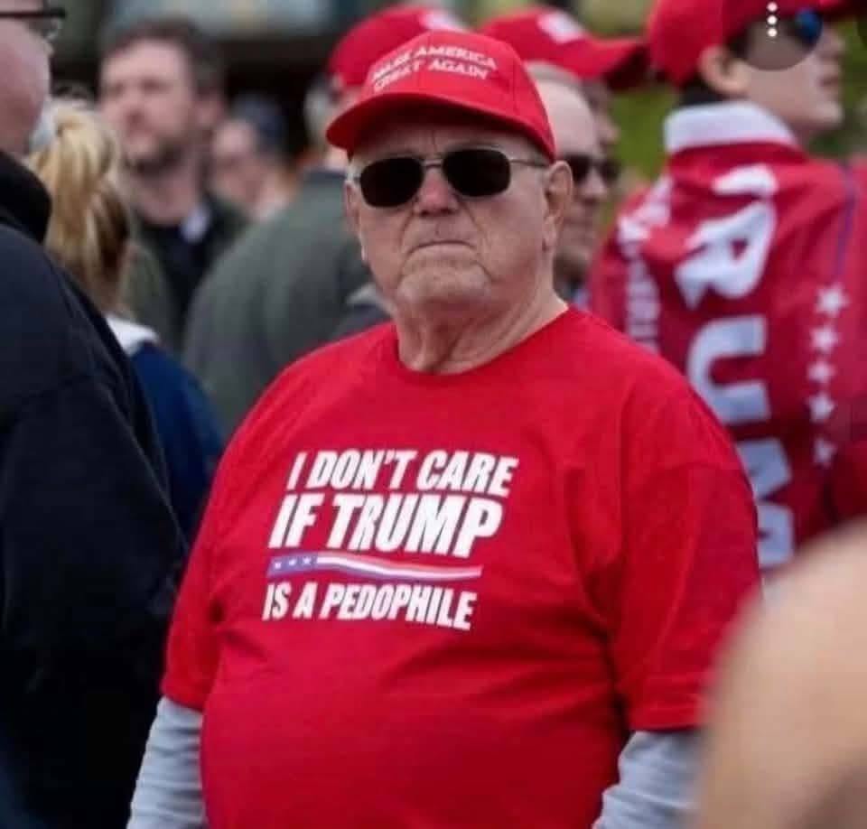 This is a political meme mocking a pro-Trump supporter. A man in the photo is dressed in red and appears visibly upset, refusing to join a political gathering. His t-shirt reads "I DON'T CARE IF TRUMP IS A PEDOPHILE,"...