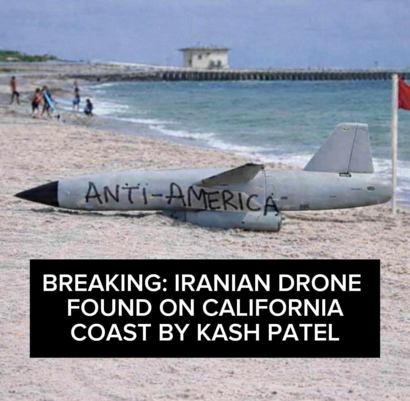 This meme depicts a gray drone lying on a beach with the words "**ANTI-AMERICA**" spray-painted across its fuselage, creating a humorous juxtaposition with the calm beach scene behind it. The caption identifies the ob...