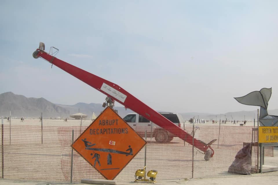 Okay, let's break down this image through the lenses you've requested. It's a potent visual, and lends itself to multiple theoretical approaches. **1. Visual Description** The photograph depicts an installation in wha...