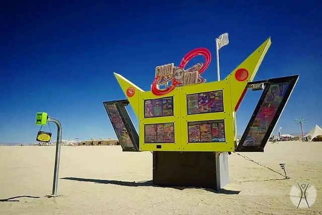 Okay, let's break down the image of this roadside-style display, potentially found at Burning Man, through the lenses requested. Please note that some of these lenses will have more applicability than others. **1. Vis...