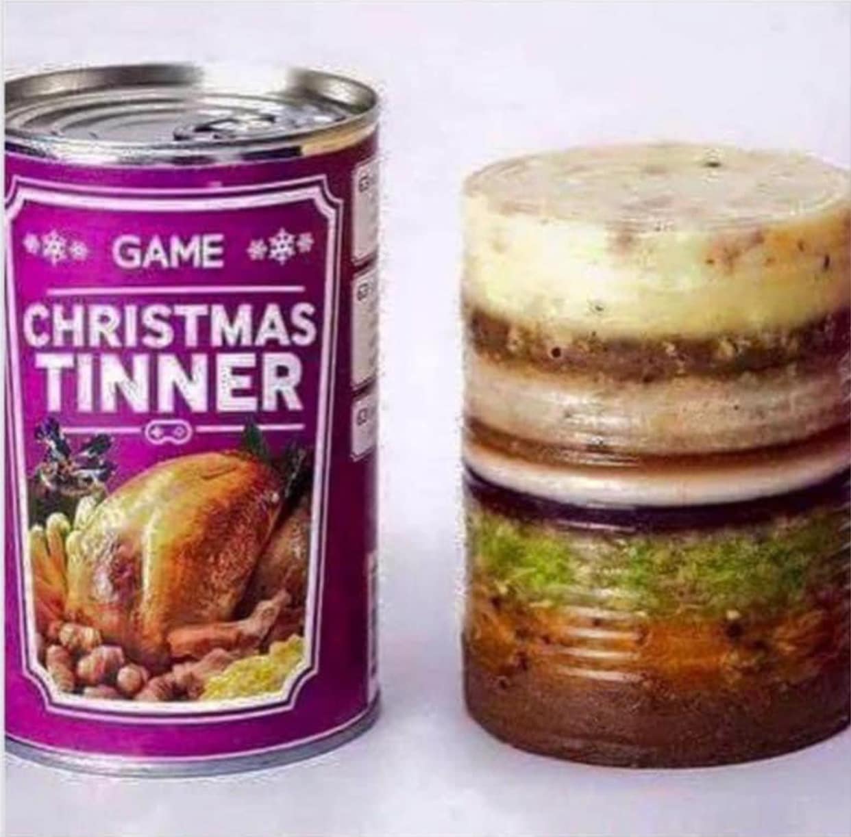 Okay, let's break down this image of the "Christmas Tinner" using the frameworks you requested. It's a truly bizarre and thought-provoking image, ripe for analysis! **Visual Description** The image depicts a canned fo...