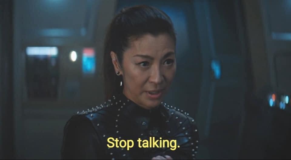 Okay, let's analyze this image using the requested theoretical frameworks, acknowledging some will be more fitting than others. **Visual Description** The image is a close-up shot of a woman, likely an actress, in a d...