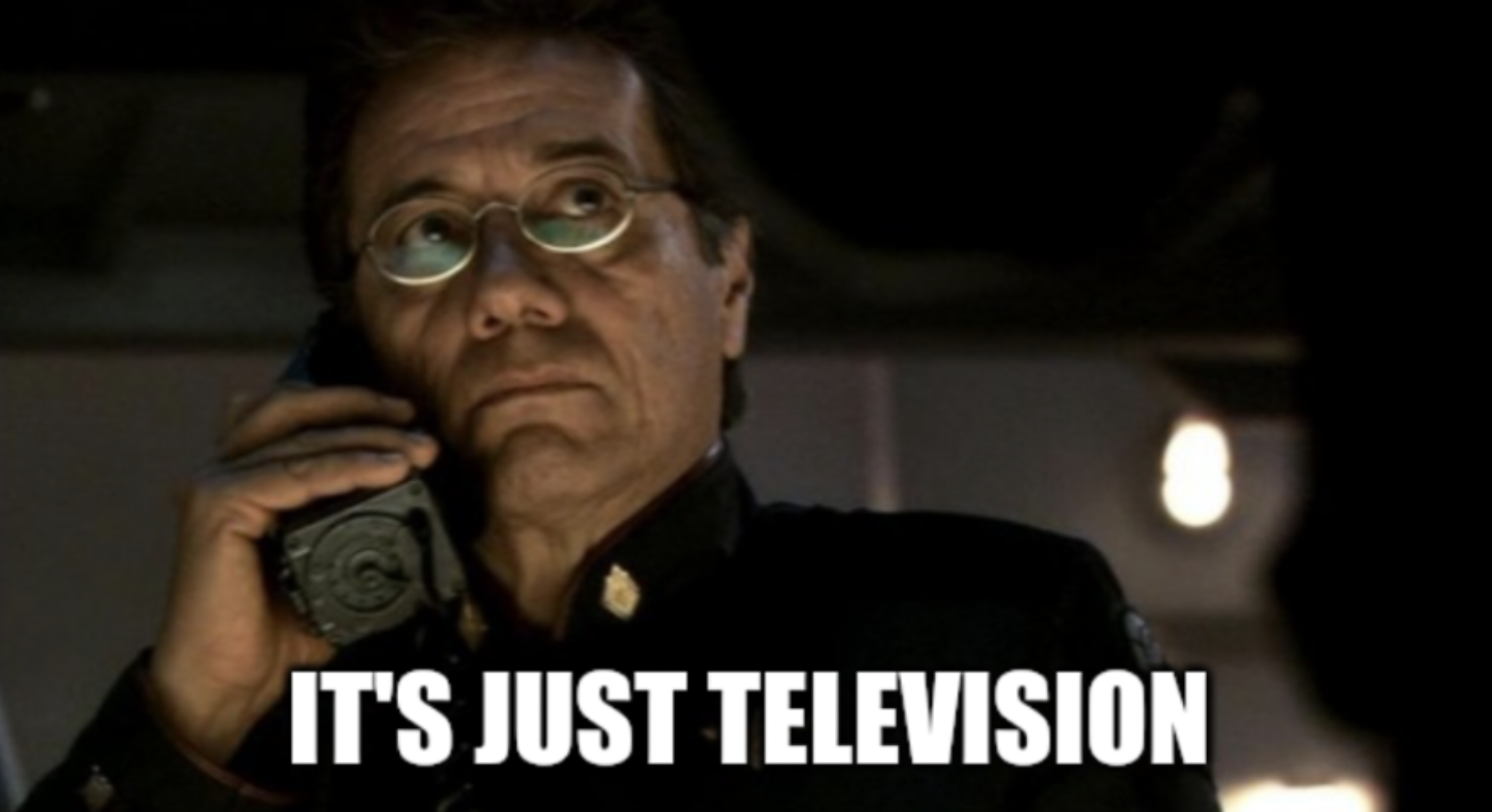 Okay, let's analyze the image of the man on the phone with the caption "It's Just Television" through the lenses you've provided. **Visual Description** The image presents a close-up shot of an older man, likely in a...