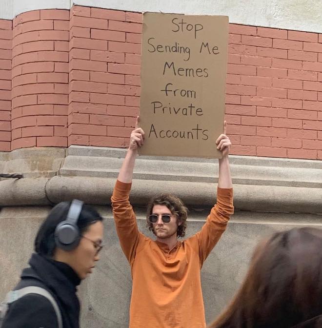 Okay, here's a breakdown of the image through the requested theoretical lenses. I'll skip sections that don't have a strong fit. ## Visual Description The image depicts a person holding a handwritten sign that reads "...