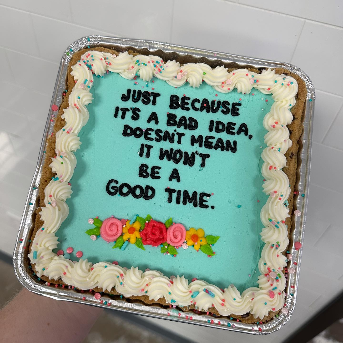 Okay, let's break down this image of a sheet cake with a somewhat ironic message, analyzed through the lenses you've requested. It's a fascinating object for this kind of analysis, as it's surprisingly rich for its ap...