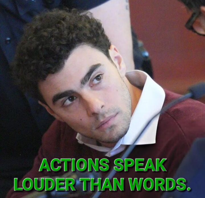 Okay, let's break down the image and apply some theoretical lenses. **Visual Description** The image is a medium close-up portrait of a young man with dark curly hair and light skin. He is wearing a dark red jacket wi...