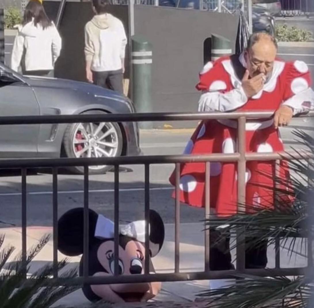 Okay, let's break down this complex image through the lenses you've requested. It's a fascinating snapshot, ripe for multi-layered analysis. ## Visual Description The image depicts a highly unusual and unsettling scen...