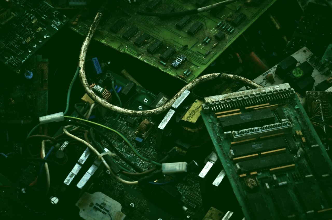 Okay, let's analyze the image provided through the lenses of various critical theories. This is a compelling image ripe for such analysis! **1. Visual Description** The image presents a top-down, close-up view of elec...