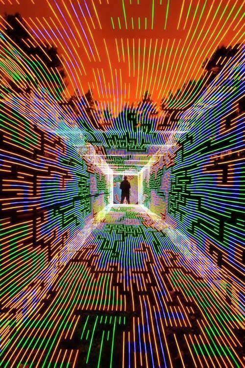 Okay, let's break down this image through the lenses of the requested theoretical frameworks. **Visual Description** The image depicts a highly visually stimulating and disorienting installation or space. It is a narr...