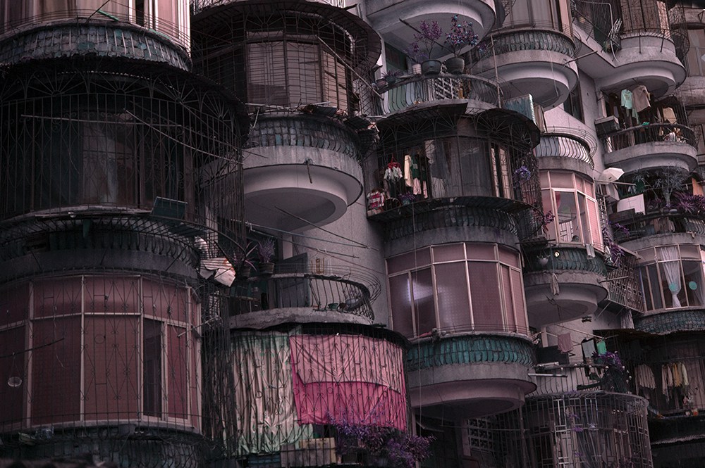 Okay, let's break down the image using the frameworks you've requested. **Visual Description** The image presents a densely packed, multi-story building facade, likely an apartment complex. The architecture is charact...