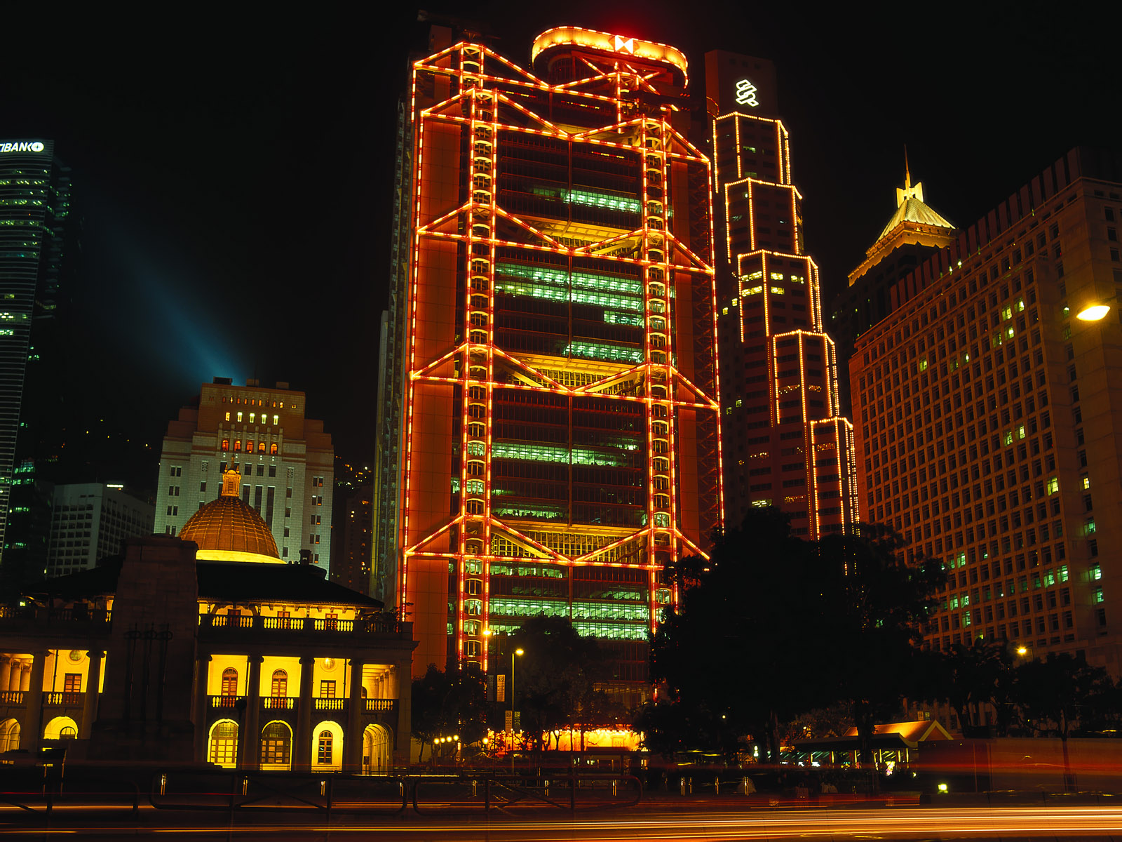 Okay, let's break down this image through several critical lenses, as requested. ## Visual Description The image depicts a nighttime cityscape, dominated by a strikingly illuminated building. This building appears to...