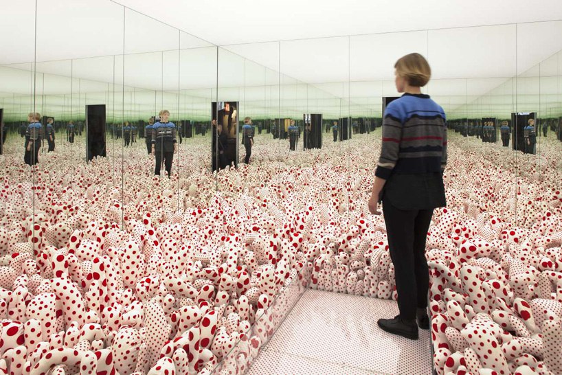 Okay, let's break down an analysis of the image using the requested frameworks. **Visual Description** The image depicts an installation art piece, most likely by Yayoi Kusama, known for her use of polka dots and imme...