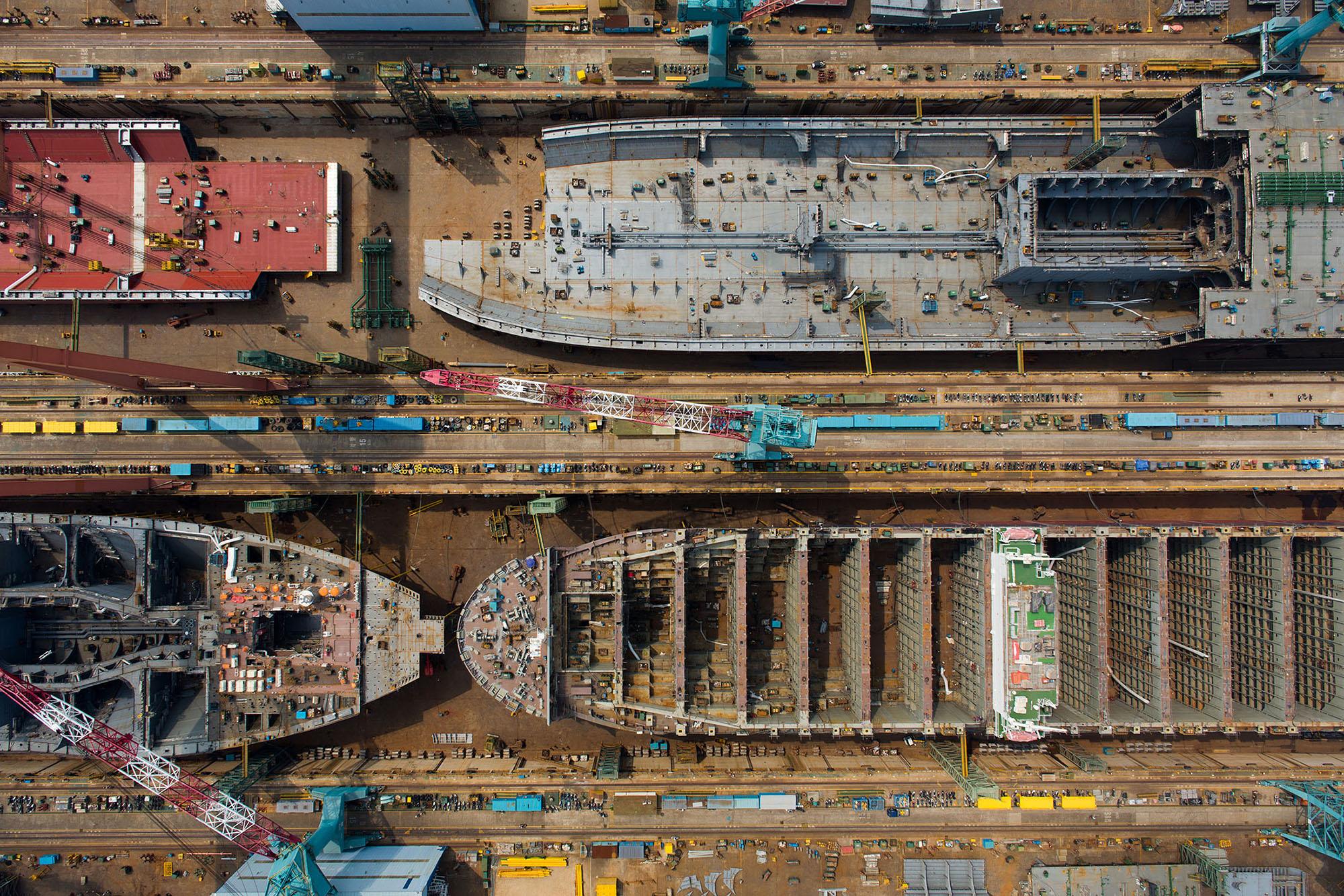 Okay, let's break down this compelling aerial photograph using the frameworks you've requested. It's a visually rich image, and multiple interpretive lenses can be applied. **Visual Description** The photograph presen...