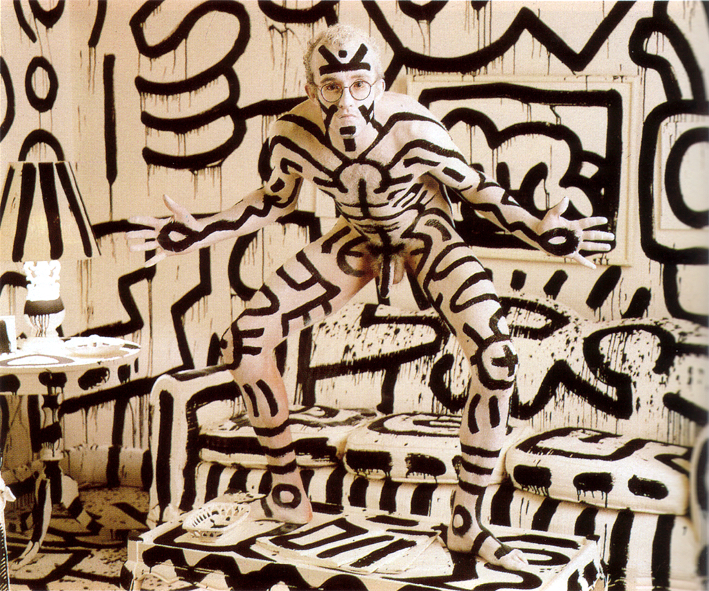 Okay, let's break down this striking image, a photograph by Tseng Kwong Chi featuring Keith Haring, through the lenses you've provided. Given the complex themes inherent in the photograph, several of these sections *w...