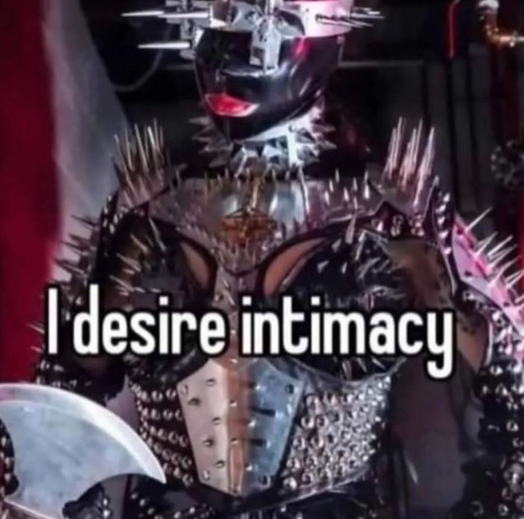 Okay, let's break down this image with the requested theoretical lenses. It's a complex image, so multiple lenses will be relevant. **Visual Description** The image depicts a person dressed in heavily stylized, gothic...