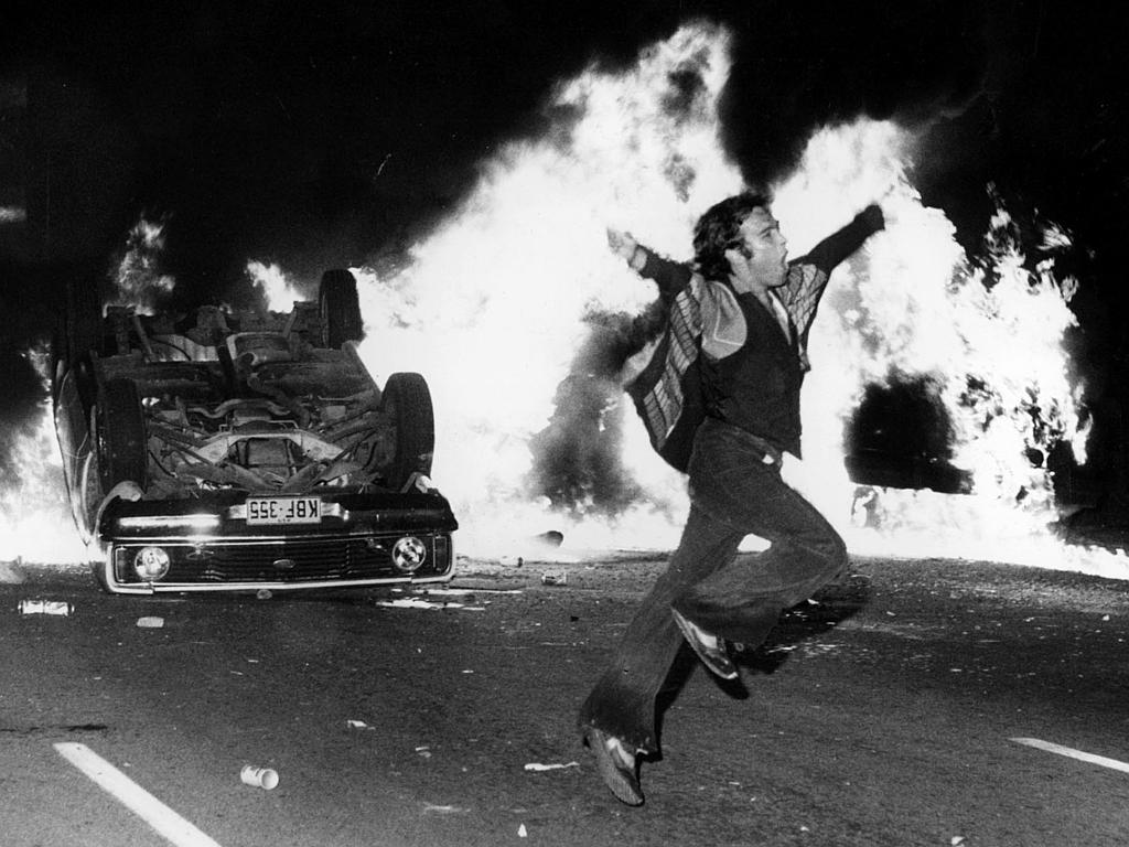 Okay, let's break down this image using the requested theoretical frameworks. It's a powerful image, and its complexities allow for multiple interpretations through various lenses. **1. Visual Description** The image...