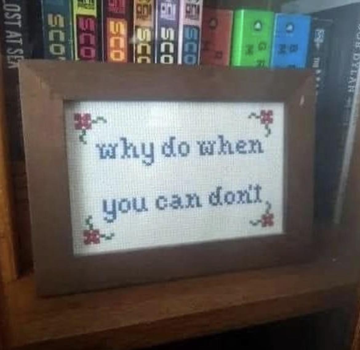 Okay, here's an analysis of the image based on the requested theoretical frameworks, with sections only where applicable. ## Visual Description The image shows a framed cross-stitch piece. The cross-stitch is on a whi...