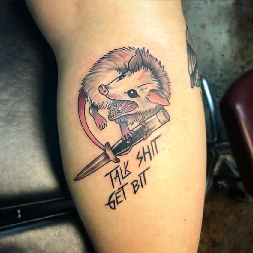 Okay, here's an analysis of the tattoo image, broken down into the requested theoretical frameworks, and addressing each section only where relevant. ## Visual Description The image shows a traditional-style tattoo on...