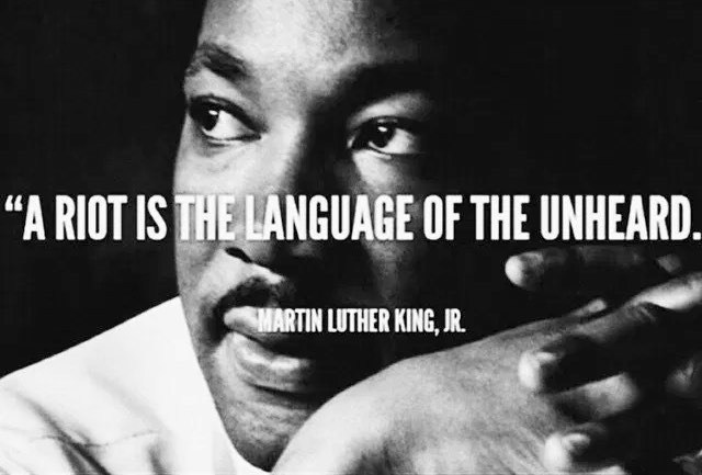 Okay, let's break down the image of Martin Luther King Jr. with the quote "A Riot Is The Language of the Unheard," through the lenses of several theoretical frameworks. **1. Visual Description** The image is a stark,...