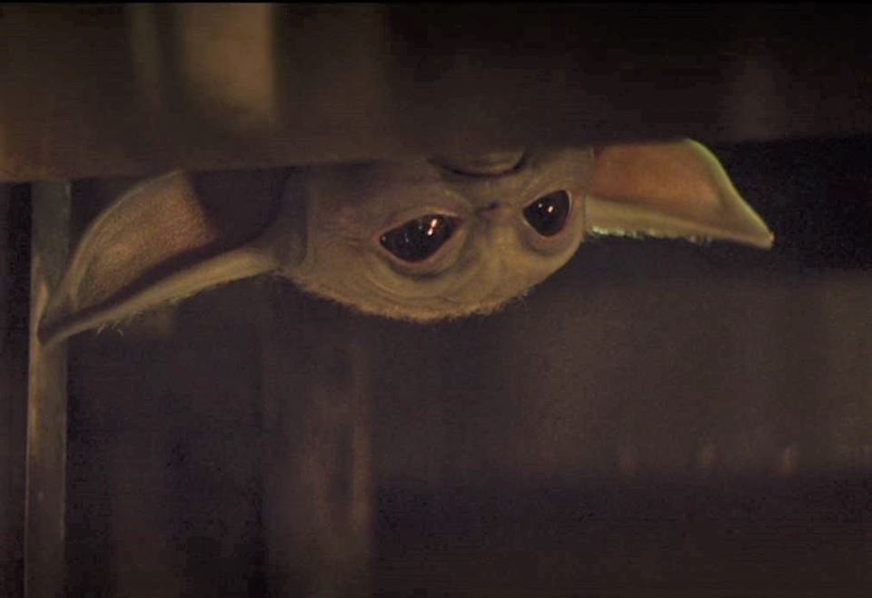 Okay, here's an analysis of the image of Grogu (Baby Yoda) peeking from under a covering, broken down into relevant theoretical sections. Since not every section is directly applicable or fruitful, I'll explain why if...