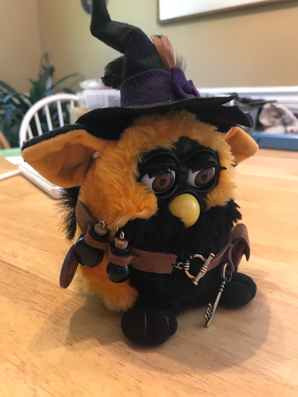 Okay, here's an analysis of the image, broken down into the sections you requested. I'll indicate when a section doesn't strongly apply. **Visual Description** The image depicts a modified Furby toy. It's primarily a...